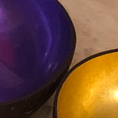 Close up of a purple and a golden bowl