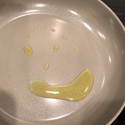 oil making a smiley face in a frying pan