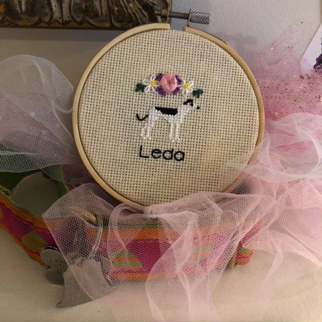 Cross stitched memento of Leda, with flowers