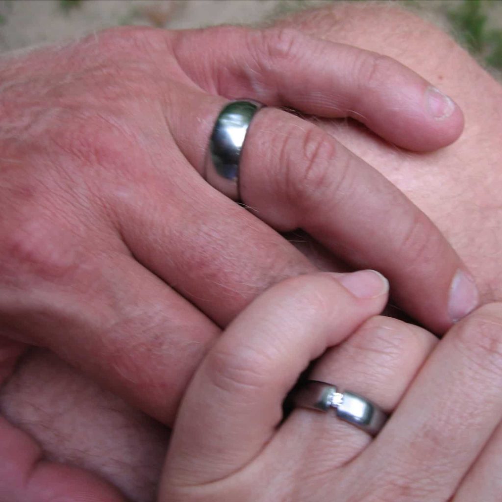 Trent's and Jule's hands, new wedding rings