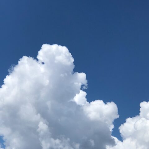 White cloud reaching up on a blue sky