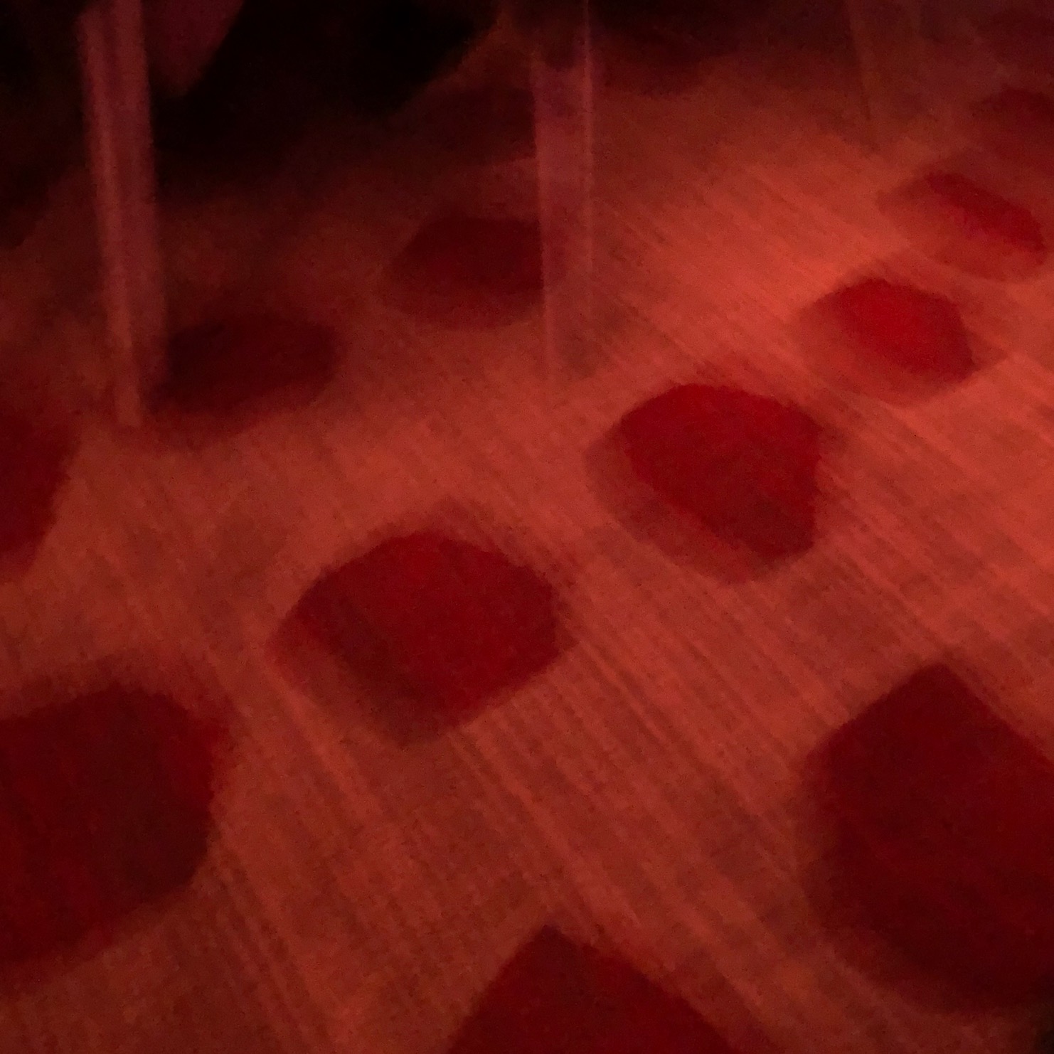 Photo of a red patterned carpet at night, blurry