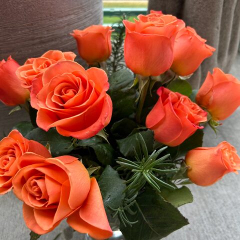 Bouquet of orange roses with greenery