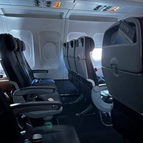 Airplane seats, mostly empty